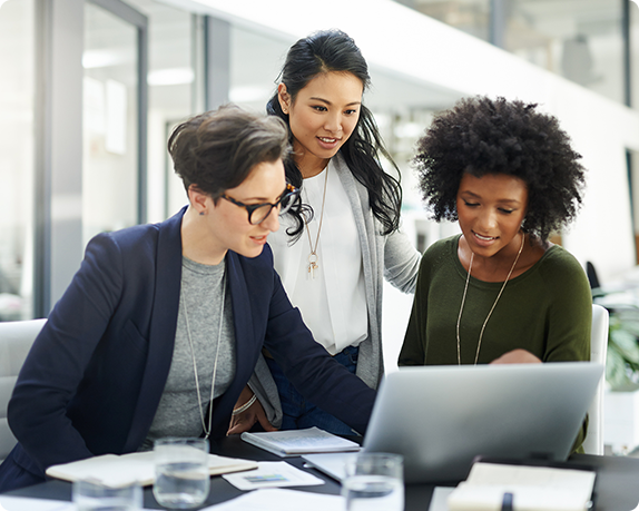 Three women working on a laptop together