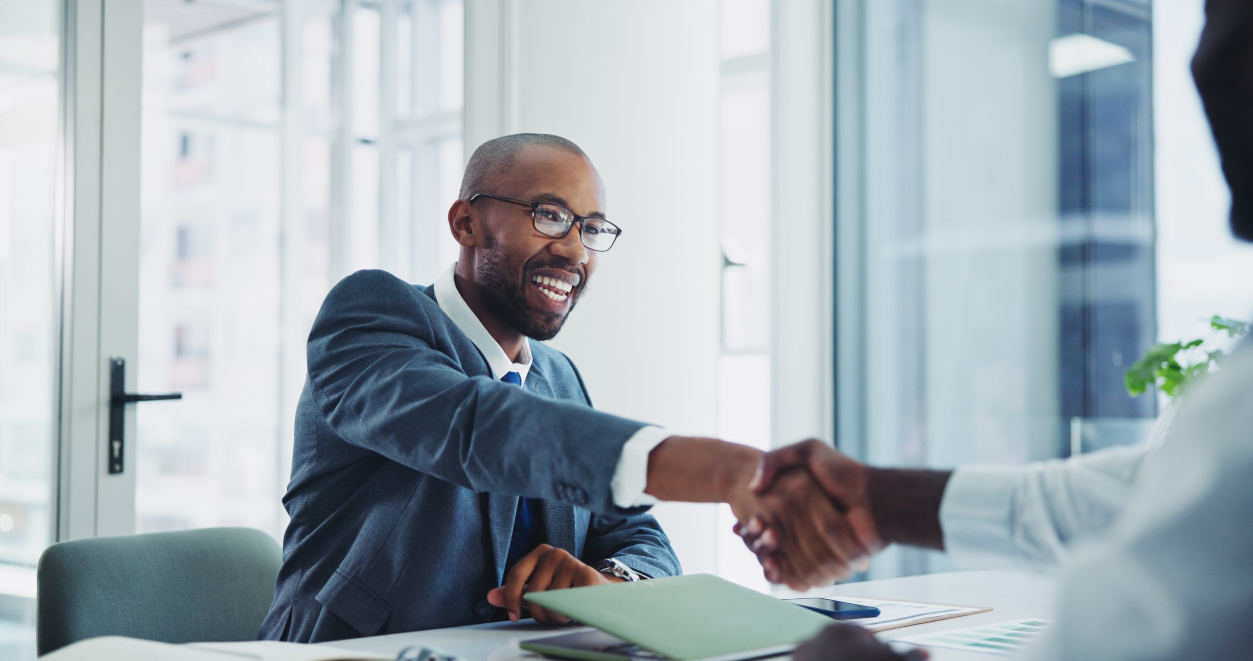 Man shaking hands in office for meeting