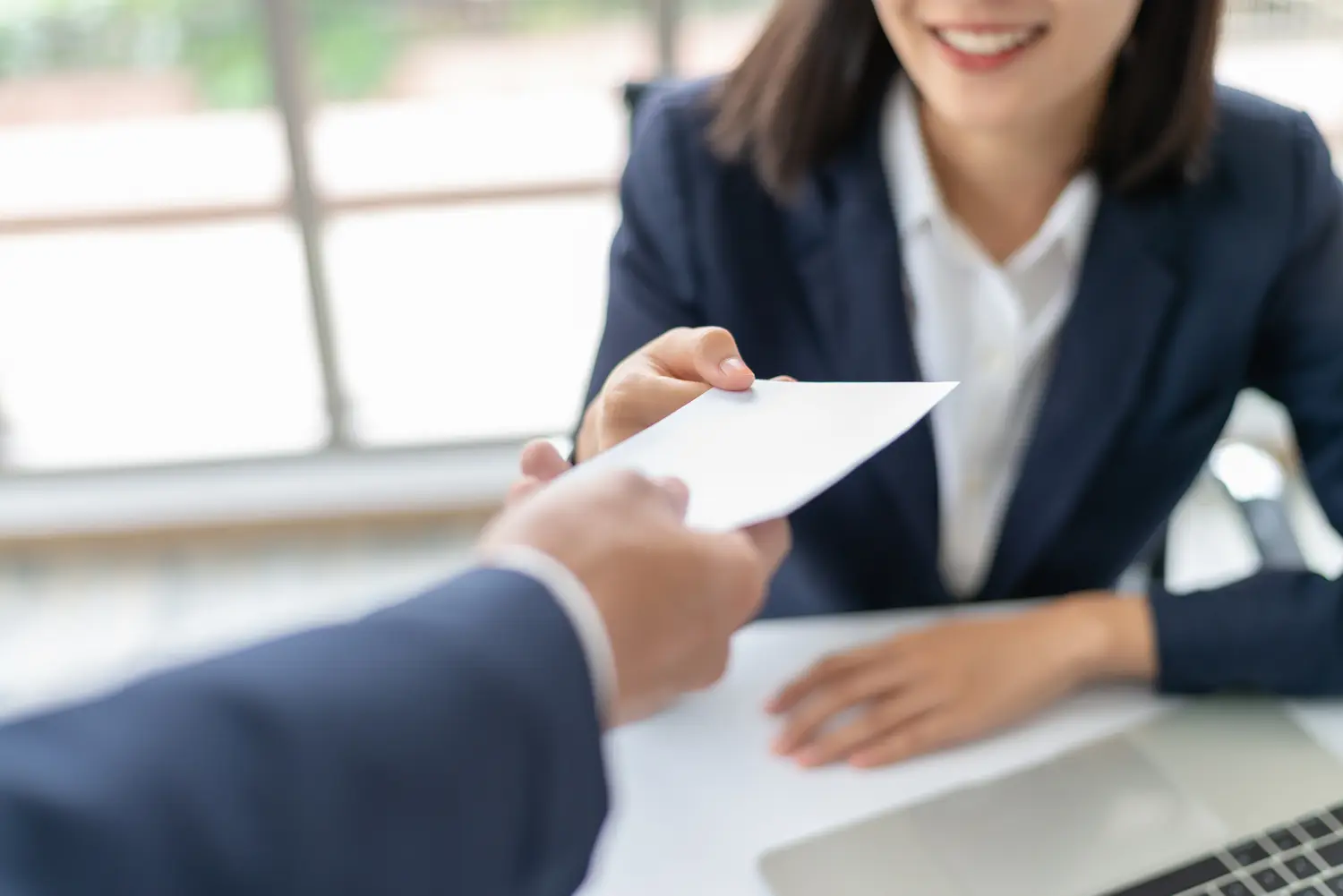 Woman being handed bonus check